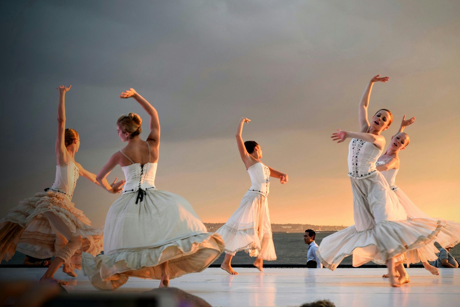 Activities Elegant ballerinas performing a captivating dance at sunset outdoors.