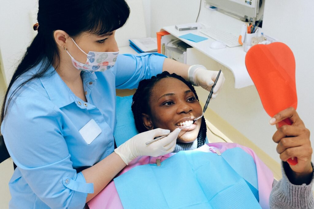 Certificate Courses A female dentist checks a patient's teeth during a dental appointment.