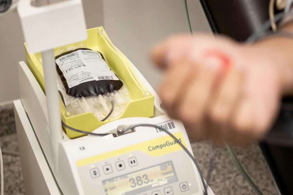 Diploma Courses Close-up of blood collection equipment during a donation process in a medical facility.